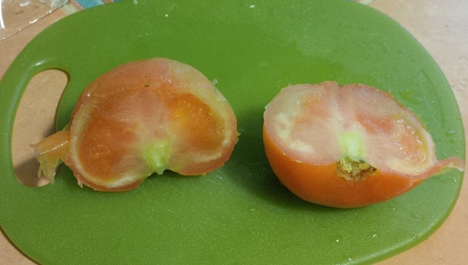 defrosted frozen tomato cut in half